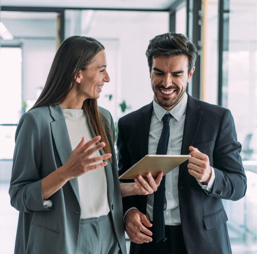 Shot of two coworkers having a discussion in modern office